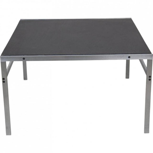Coffee table with a table top of black slate and a frame of brushed stainless steel. The table is from around the 1970s...