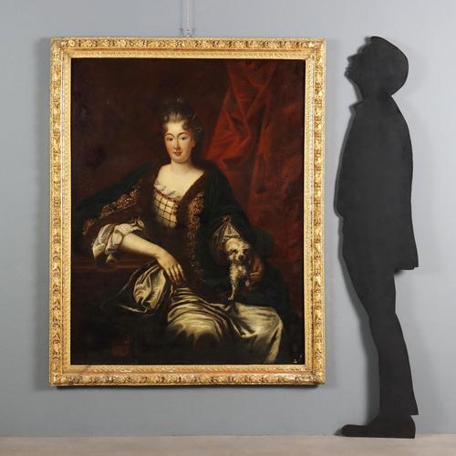 Oil on canvas. 18th-century French school. The elegant lady poses draped in a green velvet cape trimmed with fur, gold...