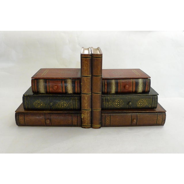 Pair of trompe-l'oeil bookends depicting stacked books, angular in shape formed from faux antique books, which also...