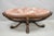 Antique Grosfeld House (attributed) French Regency Style Prince of Wales Plume Carved Oval Mahogany Coffee Table with Pink...