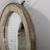 Originally a wagon wheel with an iron rim, the spokes have been removed and a mirror added to make a sophisticated rustic...