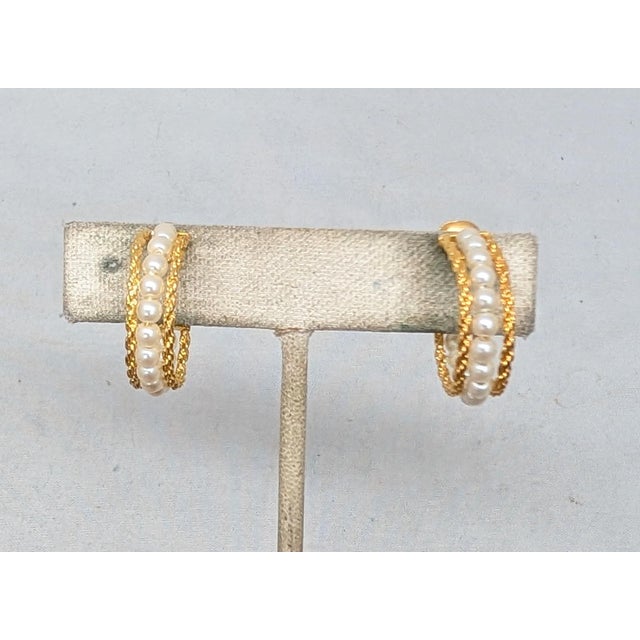 1980s goldtone wraped textured edges with a line of faux-pearls down the center adjustable clip and screw back earrings....