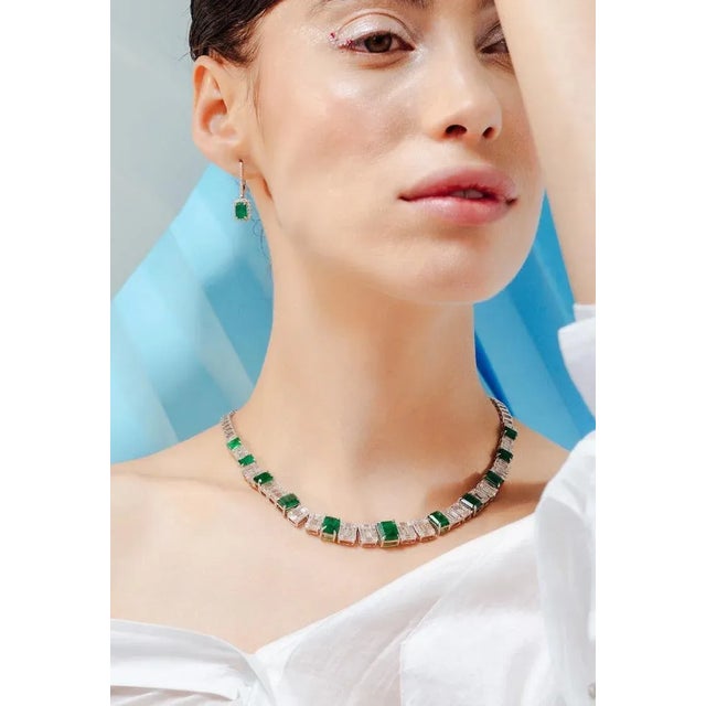 This is part of Chairish’s Fine Jewelry assortment. Vivid Green Emerald and Diamond Halo Tennis Necklace in 18K Gold...