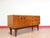 A beautiful teak short sideboard that embodies the timeless elegance of Danish style, this vintage credenza from Mid...