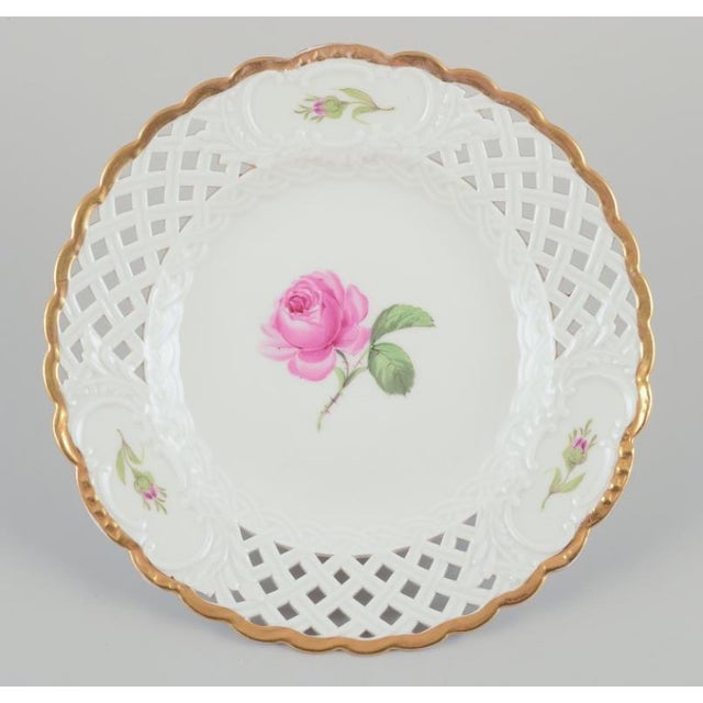 Meissen, Germany. A set of six "Pink Rose" reticulated lunch plates. Hand-painted with pink roses, gold rim. Approximately...