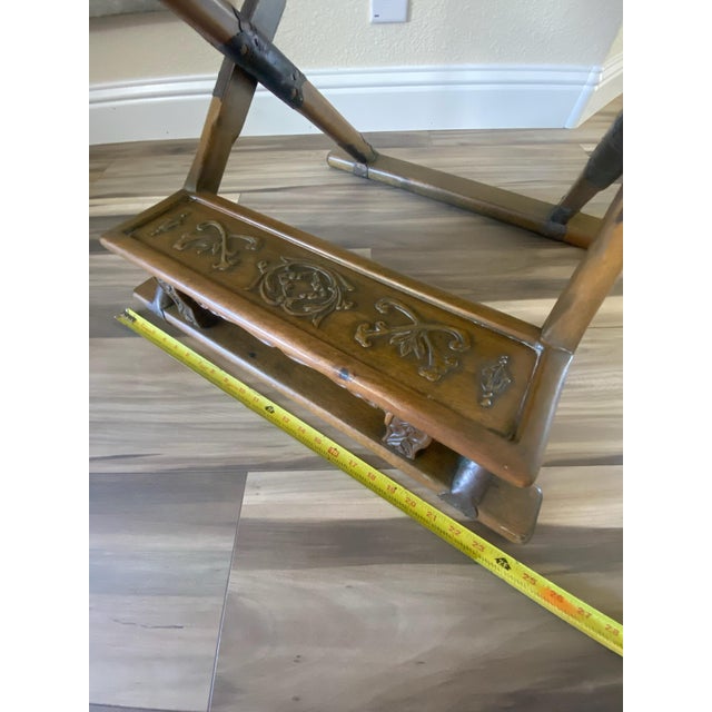 Antique-like, folding campaign chair made in Korea. Carved up the wooden back are two dragons and a flower. Golden, metal...