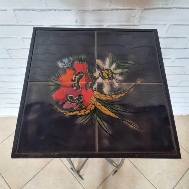Wrought iron stand from the 1950s with its earthenware tiles with floral decorations.