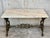 Antique cast iron French pastry style black scrolling "Butterfly" coffee table with marble top. Item features impressive...