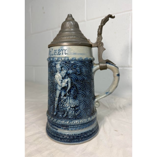 This Antique Whites Utica Stoneware "Prince of Pilsen" pewter lidded stein is a collectible beer accessory with a unique...