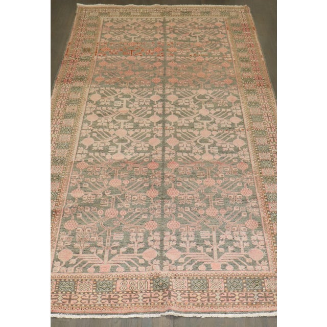 Gray salmon color 1930s Khotan rug with a pomegranate motif throughout