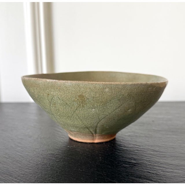 An antique Korean ceramic bowl with celadon glaze from Goryeo Dynasty circa 12th-13th century during the artistic zenith...