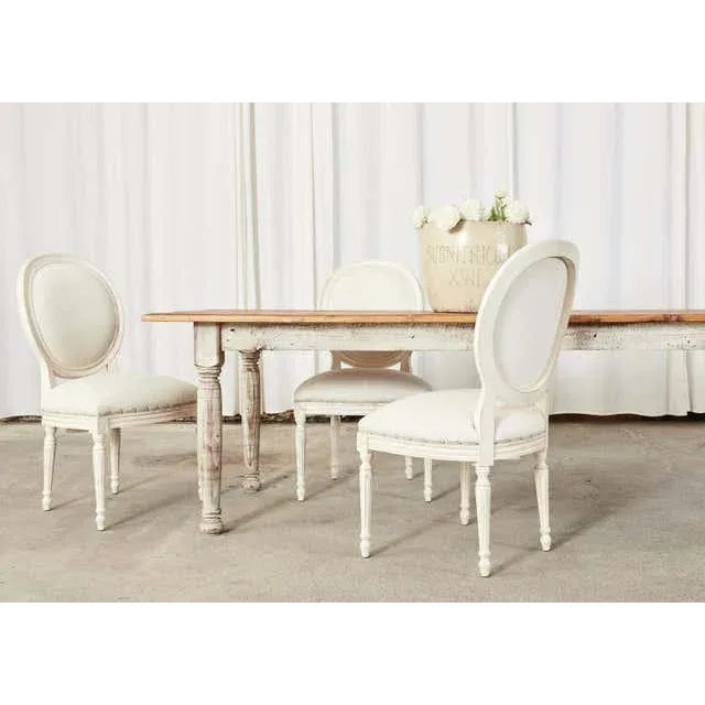 Large country American farmhouse dining table or harvest table measuring 12 feet long. Crafted from pine featuring a...