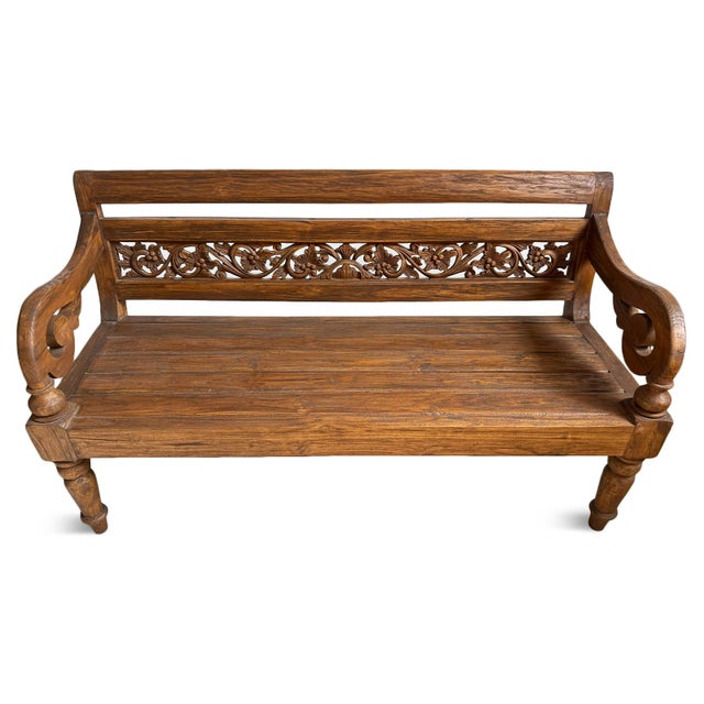 Beautifully crafted vintage Balinese teak bench, showcasing the warmth and character of solid wood in a honeyed natural...