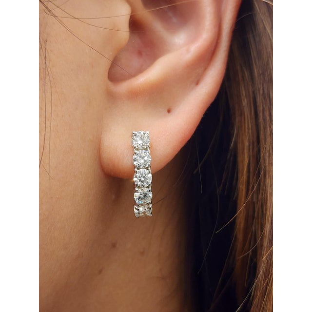 These exquisite diamond earrings are meticulously crafted in 14k white gold, showcasing modern elegance. Featuring a...
