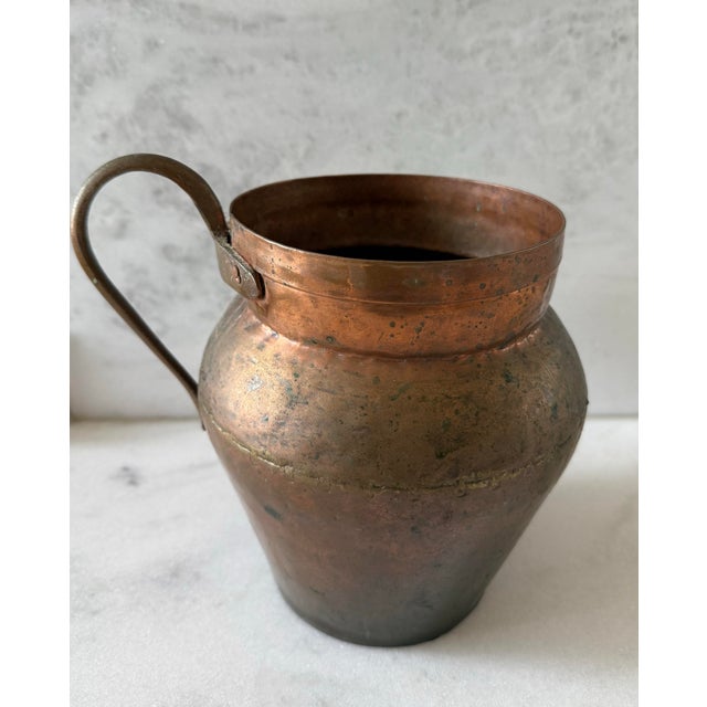 Antique copper jug or urn type vessel with a handle. Unusual construction with joined halves by a brass zipper like joint....