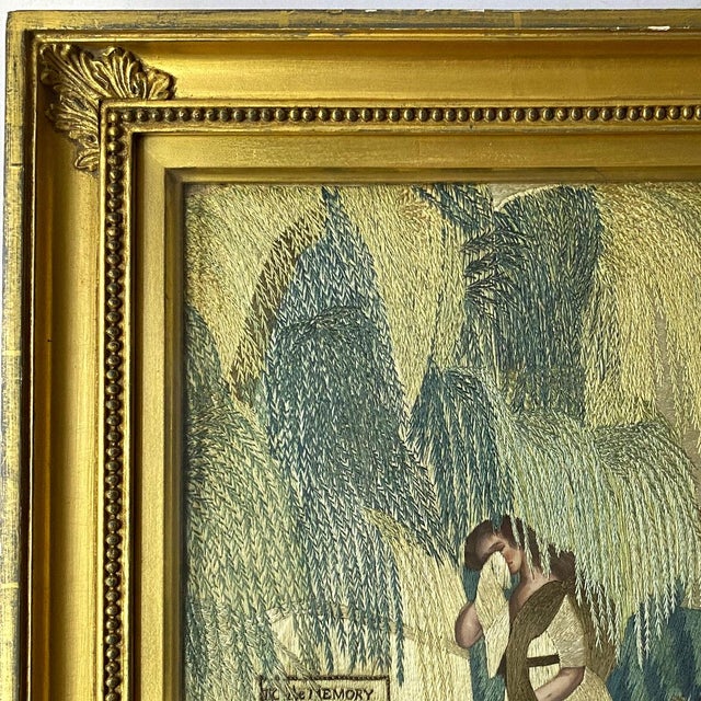 DETAILS An antique, silk embroidery mourning picture featuring a weeping woman standing under a willow tree weeping, as...