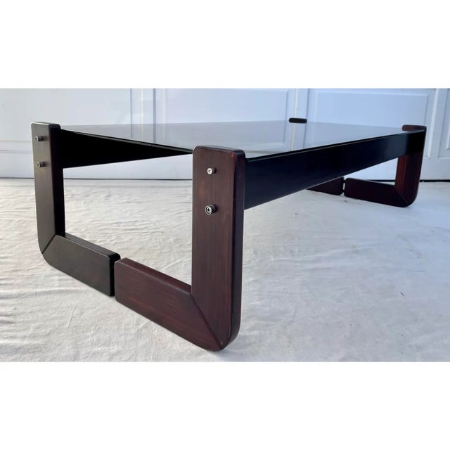 Here is a 1970s Brazilian Modernist coffee table by Percival Lafer, featuring a sculptural Brazilian hardwood frame with...