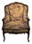 An extremely attractive bergere style armchair with antique tapestry upholstery. Elegantly carved wood frame with remnants...
