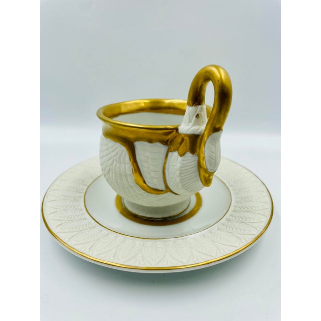A beautifully preserved collection of Sadek Gilded Swan cups and saucers! The pattern features swan feathers enveloping...