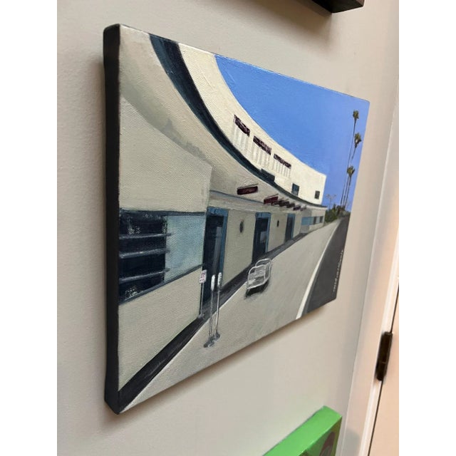 A highway recedes into the distance beyond a stand of trees.