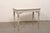 A French Neoclassical period carved and painted wood console table from the 18th century. This antique table from France...