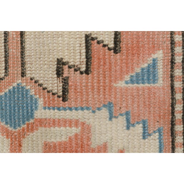 This is a vintage Turkish Oushak rug from the Mid 20th Century. The piece was hand-knotted.