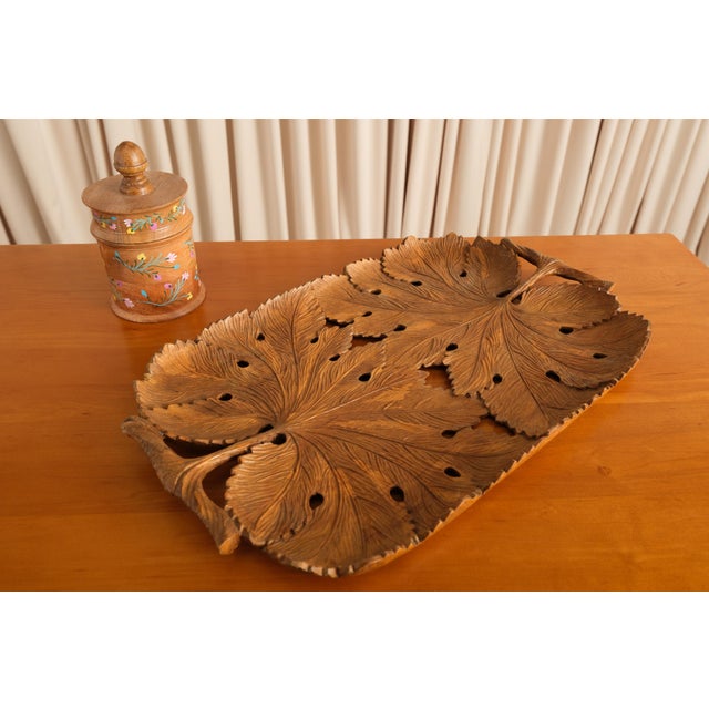 Somewhere a tree gave its best leaf as a reference and a woodcarver took it extremely seriously. This tray is carved from...