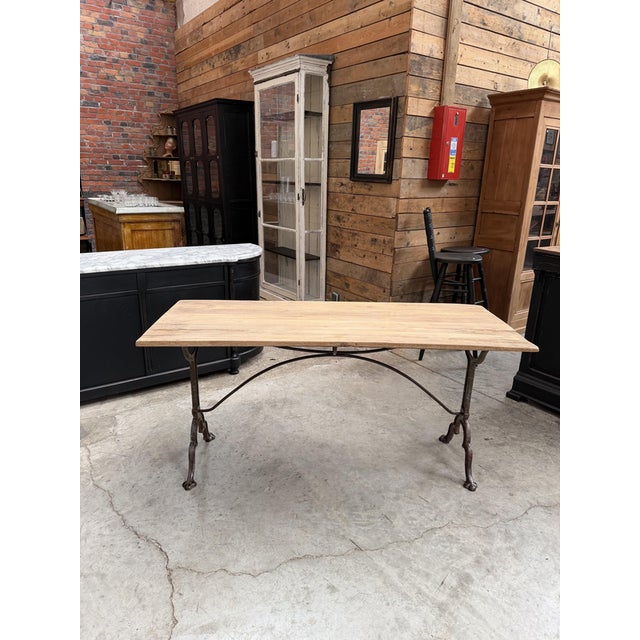 This vintage bistro table has been completely restored. It features a beautiful raw oak tabletop and a cast-iron base,...