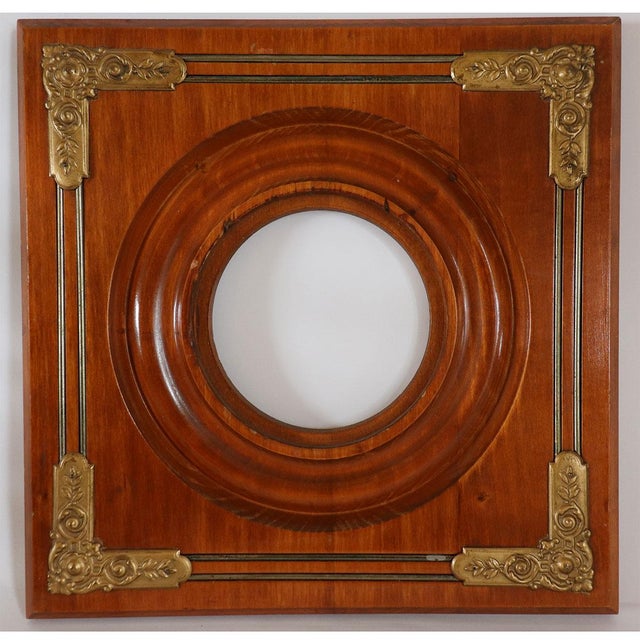 DETAILS An antique square frame with circular opening and decorative brass mounts at each corner. STYLE Victorian DATE...