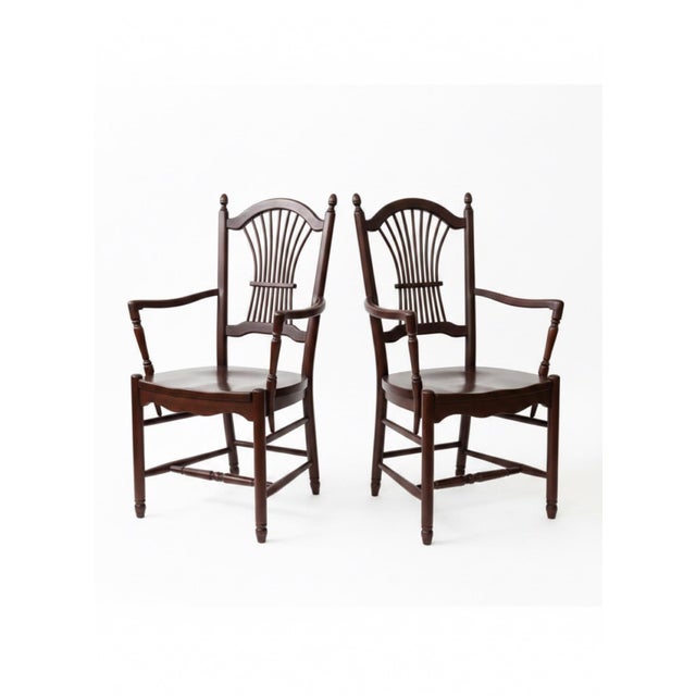 Pair of coordinating solid cherry dining armchairs by Tom Seely Furniture, reflecting the company’s tradition of finely...