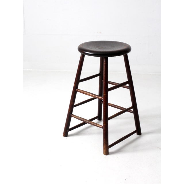 This antique farmhouse stool features clean lines and a round seat. The utilitarian piece posses a rich and desired patina...