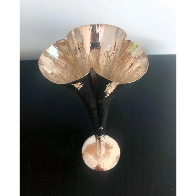 A hammered silver plate metal vase attributed to Josef Hoffmann and made by Wiener Werkstatte, circa 1920s. The vase is in...