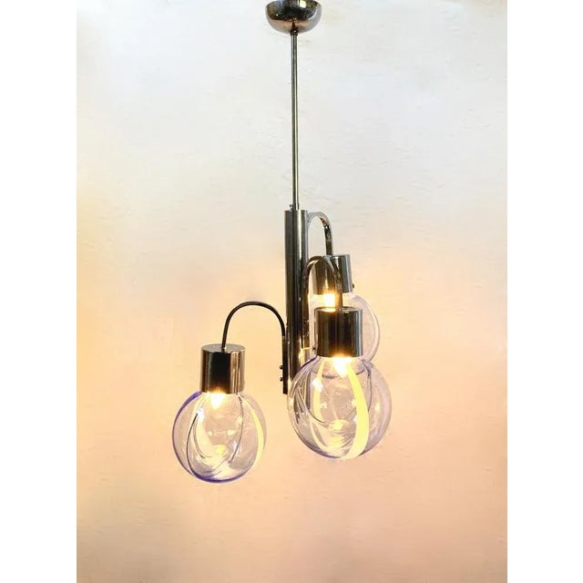 Beautiful chandelier probably from the Venini company It has a beautiful glass with a transparent and blue glass casting...