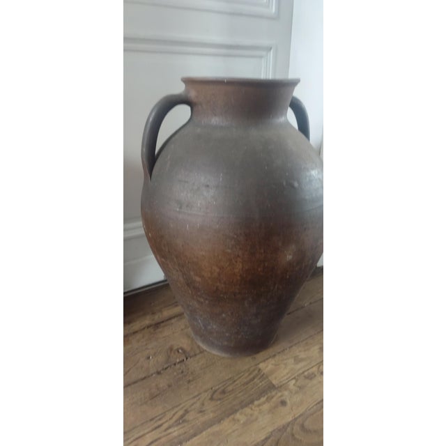 A large and characterful French stoneware jar originating from Normandy, dating to the early 20th century. This impressive...