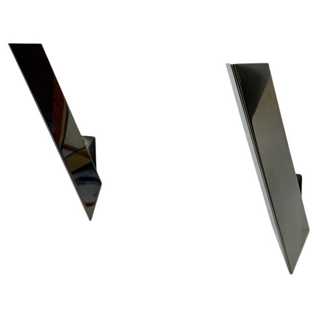 A striking pair of minimalist wall lights by the renowned austrian lighting manufacturer kalmar, dating to circa 1970....