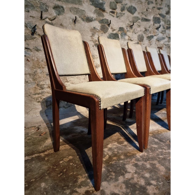 This set of five dining chairs originates from France and dates from the 1950s. Each chair is constructed from solid...