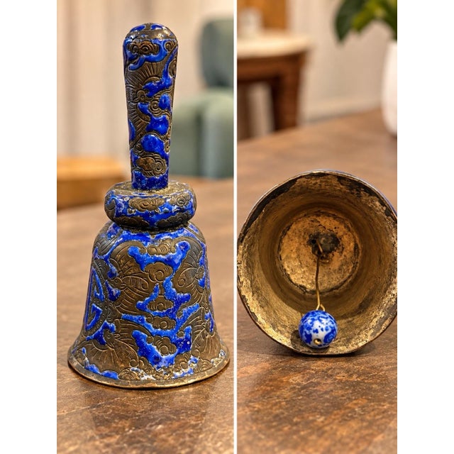 Beautiful antique metal hand bell featuring vibrant cobalt blue enamel and intricate raised designs with an Asian-inspired...