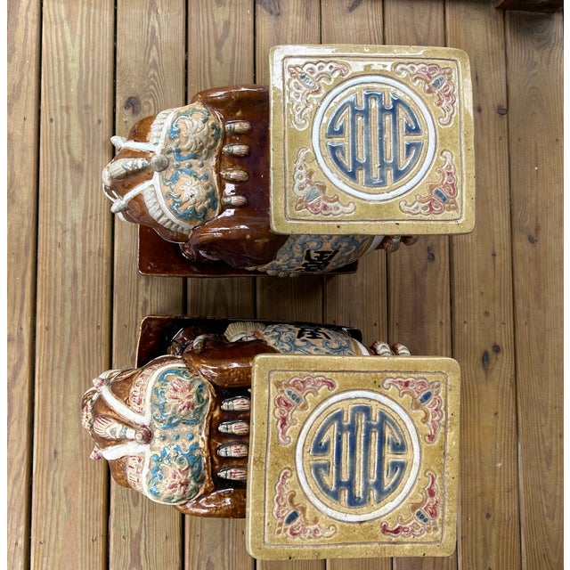 Offering a fine pair of Hollywood Regency style ceramic elephants, handpainted and finished with a high gloss glaze. They...