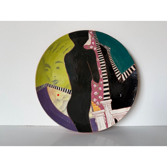 Striking hand-painted ceramic decorative plate by Lois Barton, created in the 1980s. This visually captivating Modernist...