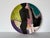 Striking hand-painted ceramic decorative plate by Lois Barton, created in the 1980s. This visually captivating Modernist...