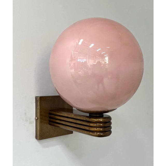 Italian Art Deco style wall light with Opaque Coral Murano glass globe mounted on Bronzed finish frame, designed by Fabio...