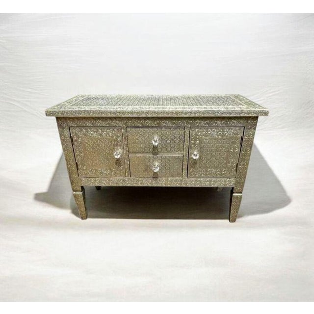Transform your home with this stunning Moroccan Metal Embossed Cabinet Handcrafted Detail: Intricate, hand-embossed silver...