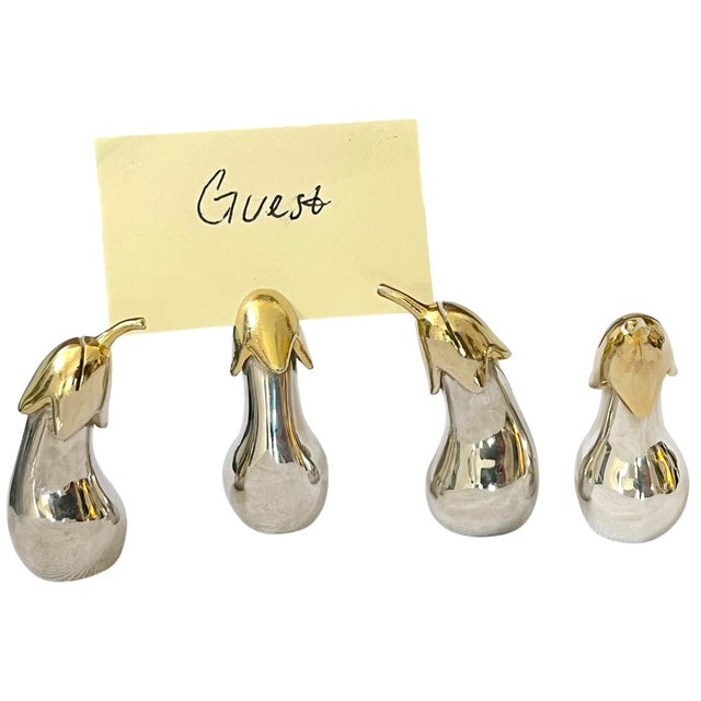 A chic set of four vintage eggplant-form place card holders, rendered in gleaming silver tone with contrasting gold-tone...