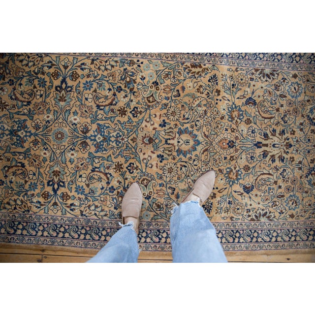 :: Unusual size and proportion with an allover covered field of palmettes, blossoms, paisley botehs, scrolled leaves with...