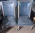 A pair of Restoration hardware blue leathered dinning chairs with upholstered backings.