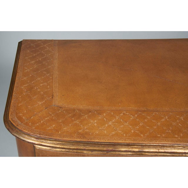 Pair of French Louis XVI style leather wrapped commodes with bronze mounts. This handsome and elegant pair of large-scale...