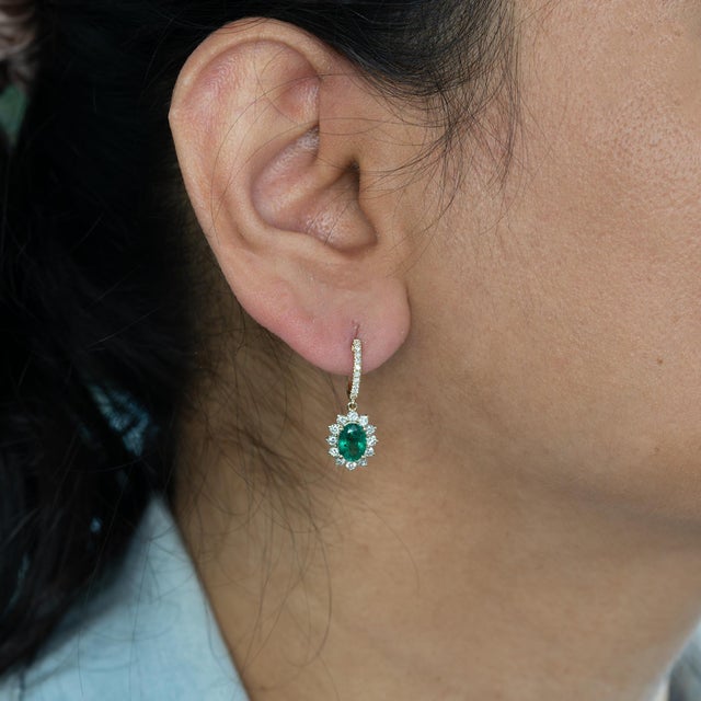 Rich 1.6Ct emeralds showcase a deep, vibrant green, accented by natural diamonds for a refined sparkle. Set in solid 14K...