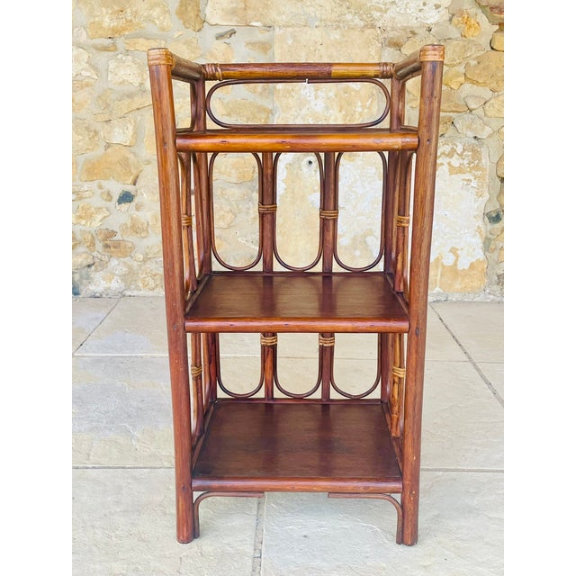Vintage, bamboo and rattan, 3-tiered floor shelf, circa 1960's. piece has three shelves made of a dark-brown colored wood,...
