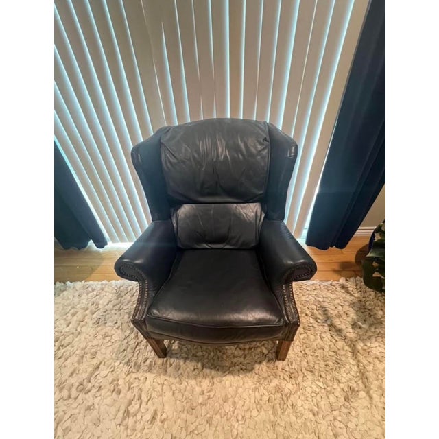 Beautiful Broyhill leather wingback chair. The color is navy blue. Very comfortable and stylish.