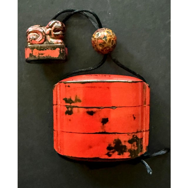 A Japanese three-case inro with stringed carved netsuke and bead ojime from early Edo period circa 17th century. The trio...